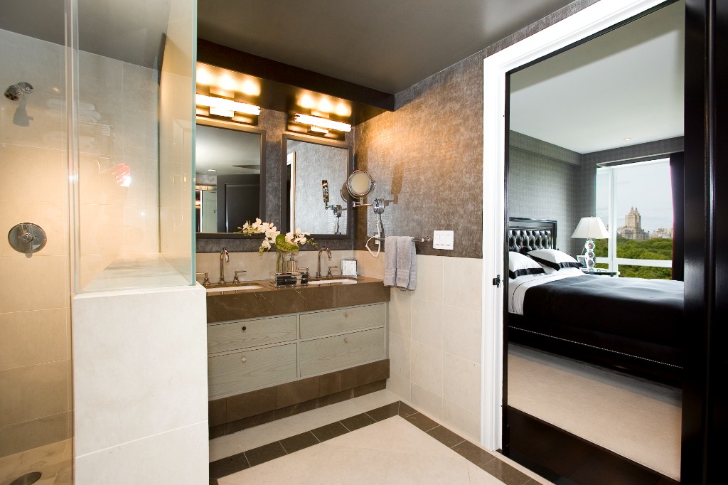 160 Central Park South, Unit 1005 Manhattan, NY 10019 - Photo 4 of 21 a en suite bathroom with a sink a mirror and a shower