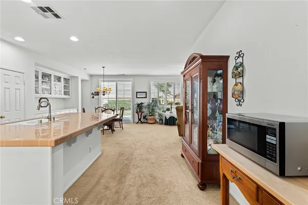 a large white kitchen with stainless steel appliances