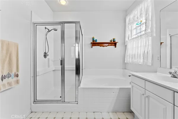 a bathroom with a shower sink and mirror