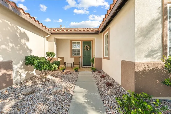 a view of a house with potted plants