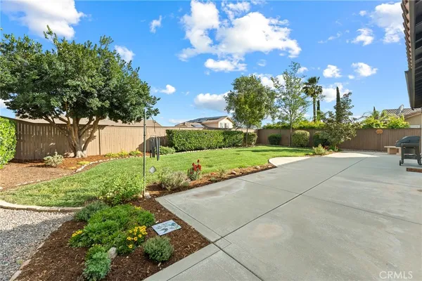 a backyard of a house with table and chairs