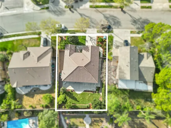 an aerial view of residential house with outdoor space and swimming pool
