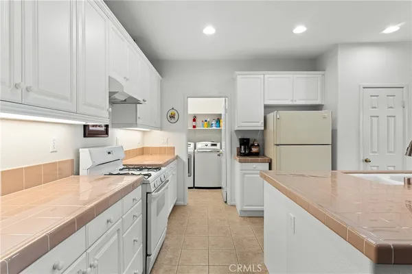 a kitchen with a stove a refrigerator and a sink
