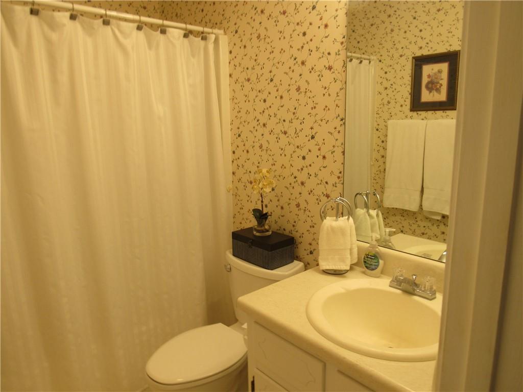 73 Cotton Bend Cartersville, GA 30120 - Photo 9 of 9 a bathroom with a sink a toilet and shower curtain