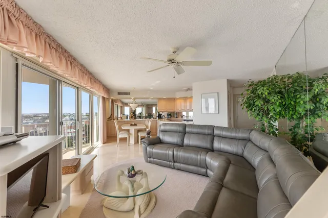 a living room with furniture a chandelier and a fireplace