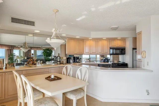 a kitchen with stainless steel appliances kitchen island granite countertop a sink and cabinets