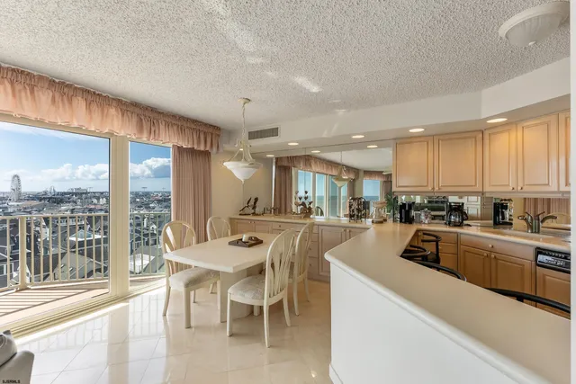 a kitchen with a table chairs sink and cabinets