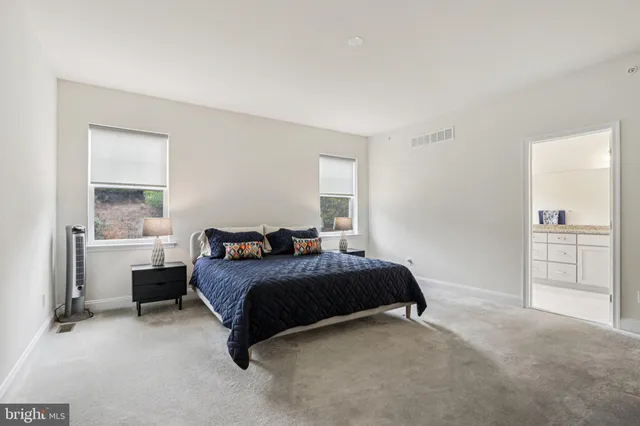 a bedroom with bed and a couch