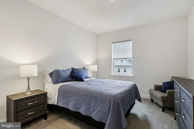 a bedroom with a bed and a mirror on dresser