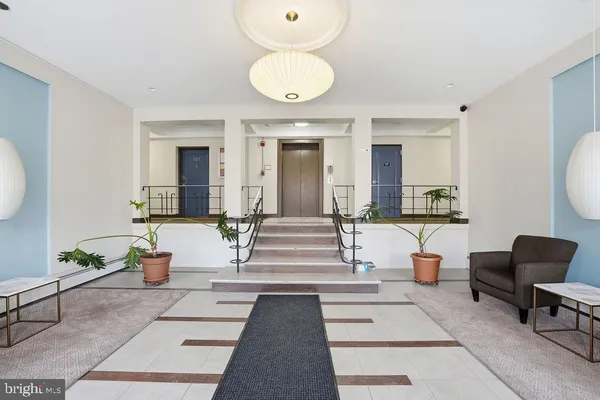 a living room with furniture and a mirror