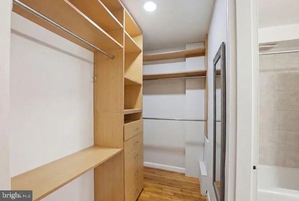 a white refrigerator freezer and a wooden floor