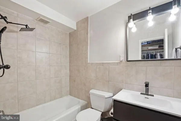 a bathroom with a sink mirror and toilet