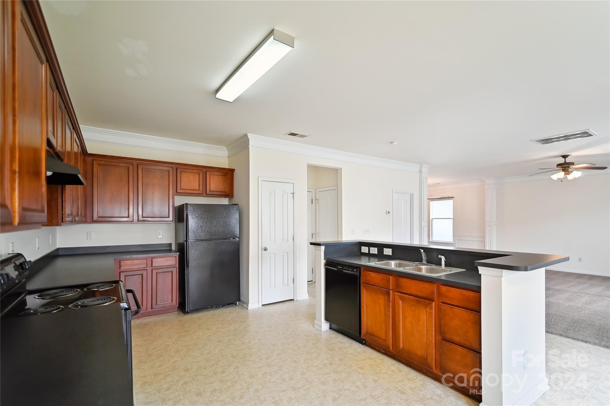 613 Latimer Way Monroe, NC 28110 - Photo 13 of 38 a kitchen with stainless steel appliances granite countertop a refrigerator a stove and a sink with wooden cabinets