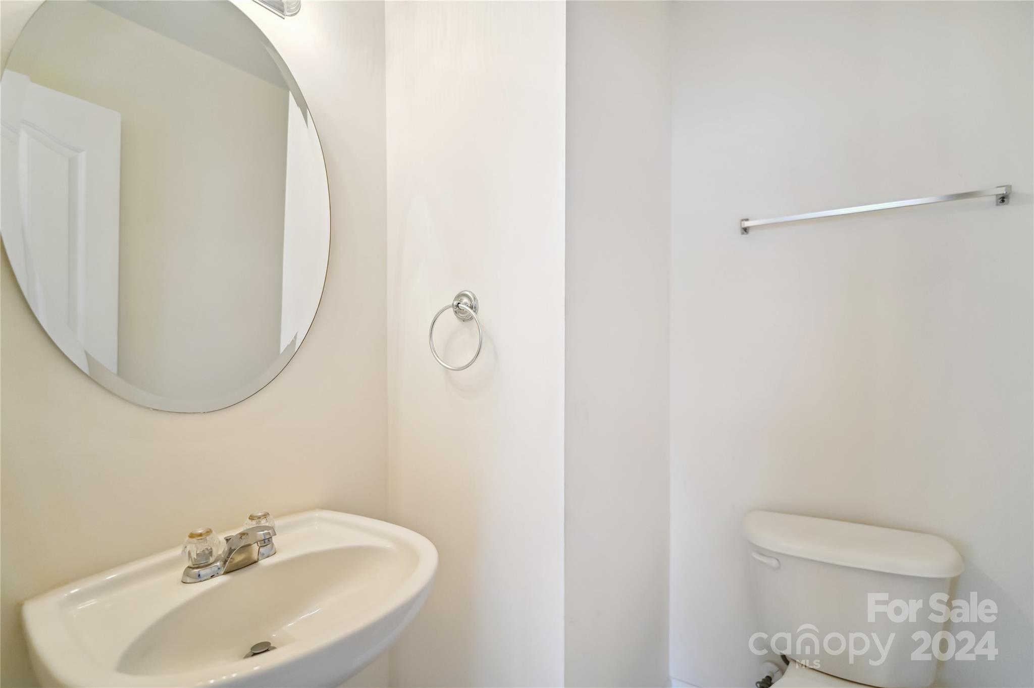 613 Latimer Way Monroe, NC 28110 - Photo 20 of 38 a bathroom with a sink a toilet and a mirror