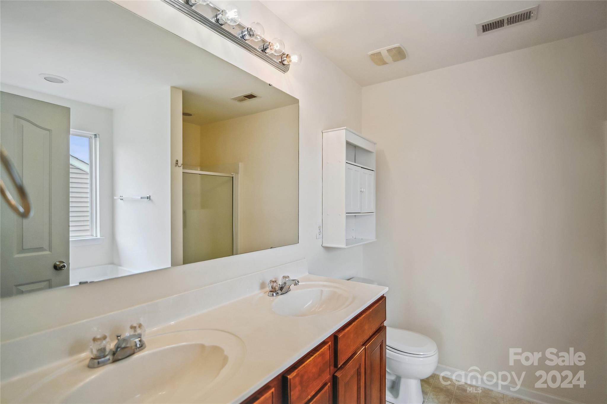 613 Latimer Way Monroe, NC 28110 - Photo 32 of 38 a bathroom with a sink toilet and mirror