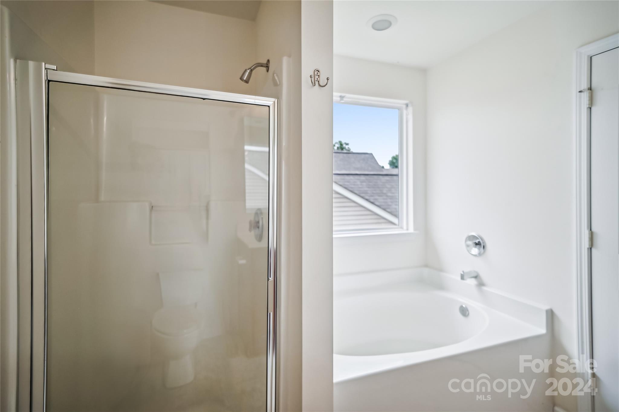 613 Latimer Way Monroe, NC 28110 - Photo 33 of 38 a bathroom with a bathtub and a shower