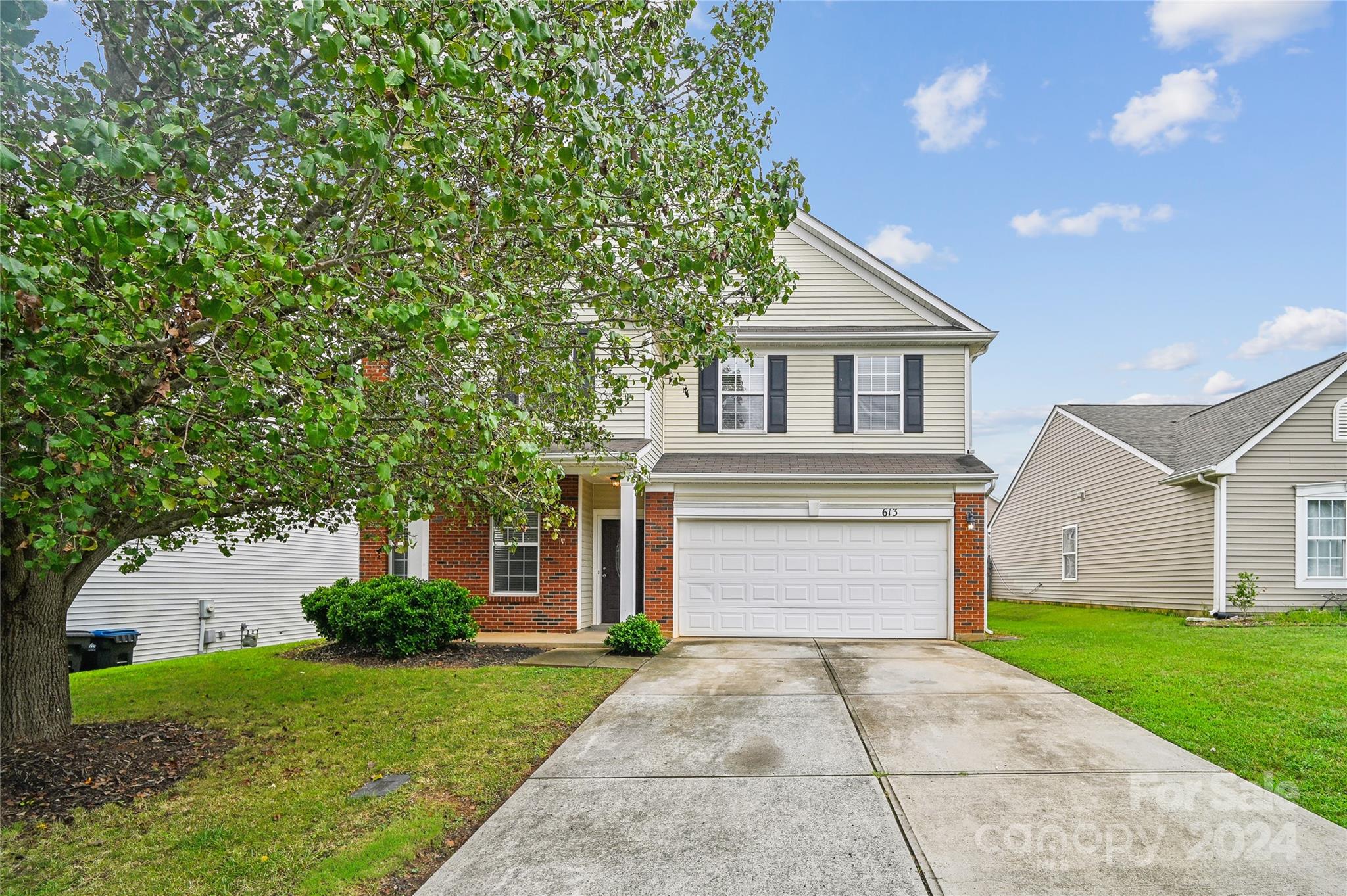 613 Latimer Way Monroe, NC 28110 - Photo 5 of 38 a front view of a house with a yard and garage