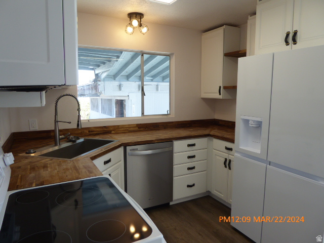 533 East 100 North Price, UT 84501 - Photo 3 of 6 Modern kitchen featuring white cabinetry, wood-finish countertops, stainless steel appliances, and wood-finish flooring