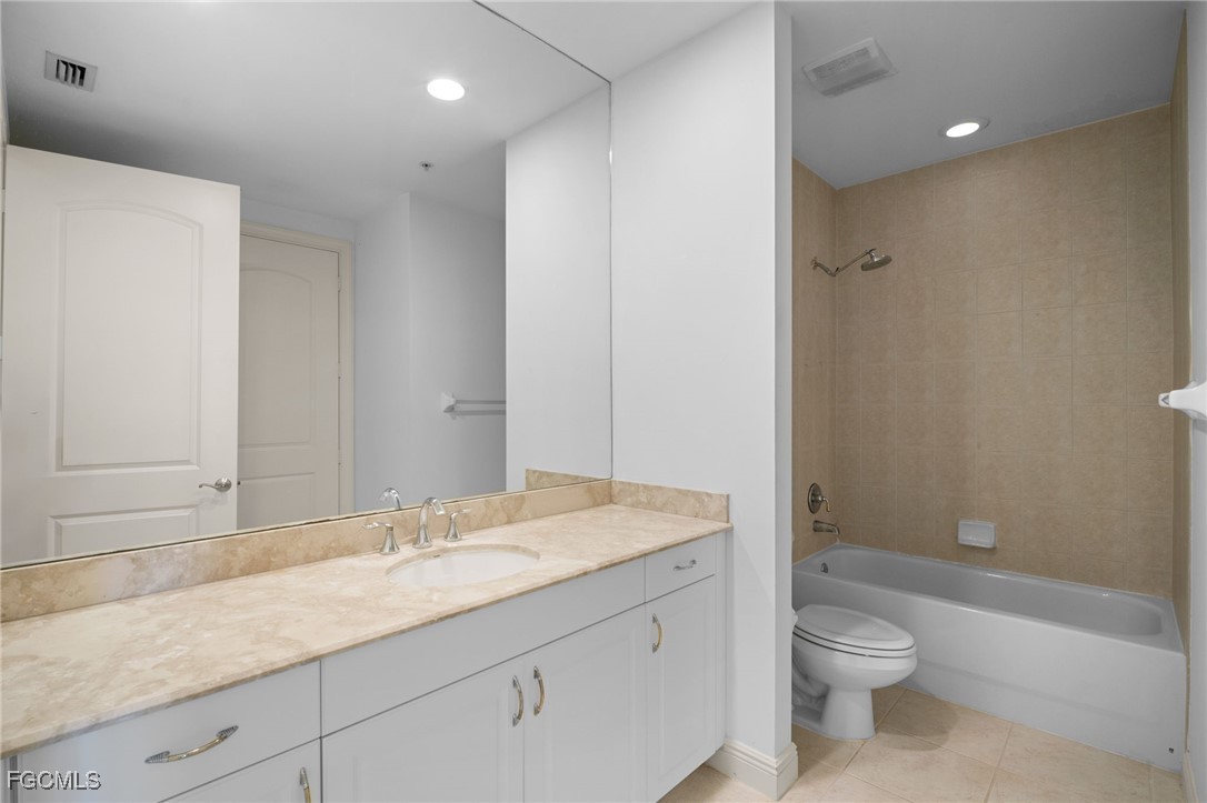 2090 West First Street, Unit F2806 Fort Myers, FL 33901 - Photo 23 of 34 a bathroom with a granite countertop sink a toilet and shower