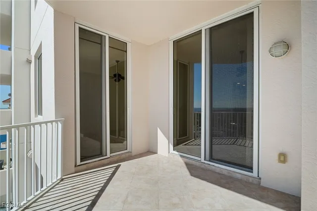 a view of a hallway with wooden floor and glass door