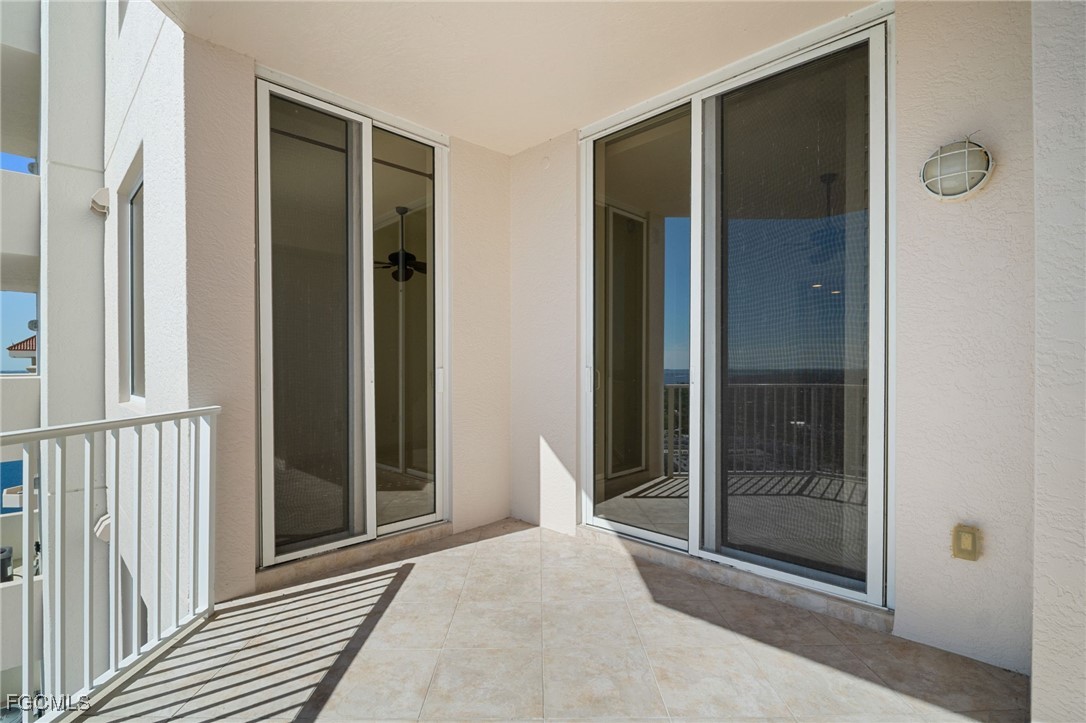 2090 West First Street, Unit F2806 Fort Myers, FL 33901 - Photo 5 of 34 a view of a hallway with wooden floor and glass door