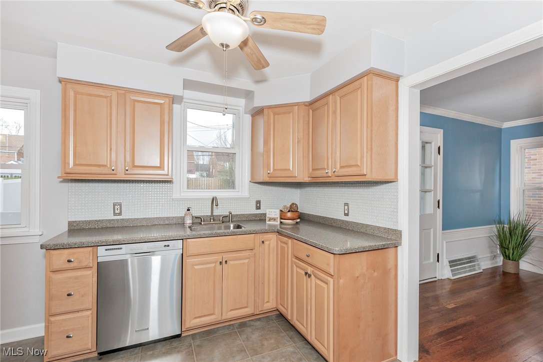 3826 Silsby Road Cleveland, OH 44118 - Photo 11 of 41 Kitchen featuring light brown cabinets, visible vents, decorative backsplash, stainless steel dishwasher, and a sink