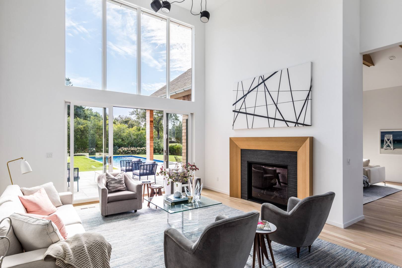 370 Pantigo Road East Hampton, NY 11937 - Photo 12 of 33 a living room with furniture a fireplace and floor to ceiling windows