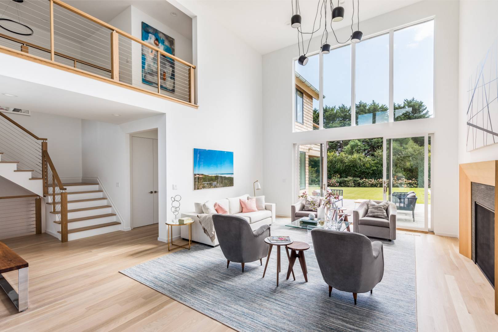 370 Pantigo Road East Hampton, NY 11937 - Photo 13 of 33 a living room with furniture a large window and wooden floor