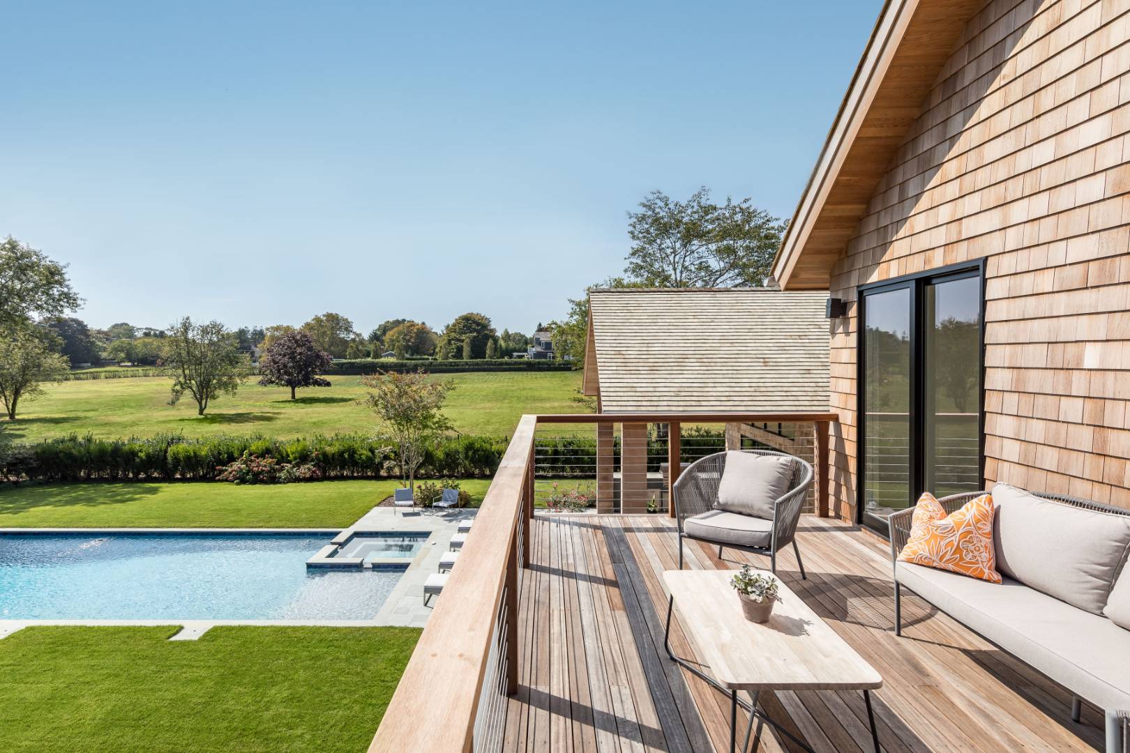 370 Pantigo Road East Hampton, NY 11937 - Photo 16 of 33 a view of a patio with couches potted plants and a big yard