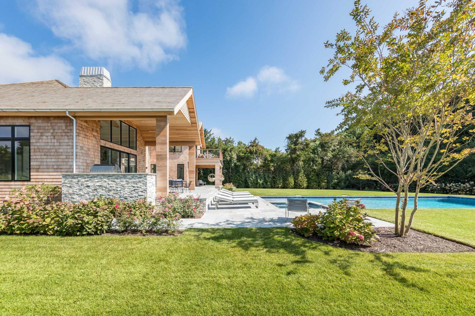 370 Pantigo Road East Hampton, NY 11937 - Photo 17 of 33 a front view of a house with a yard