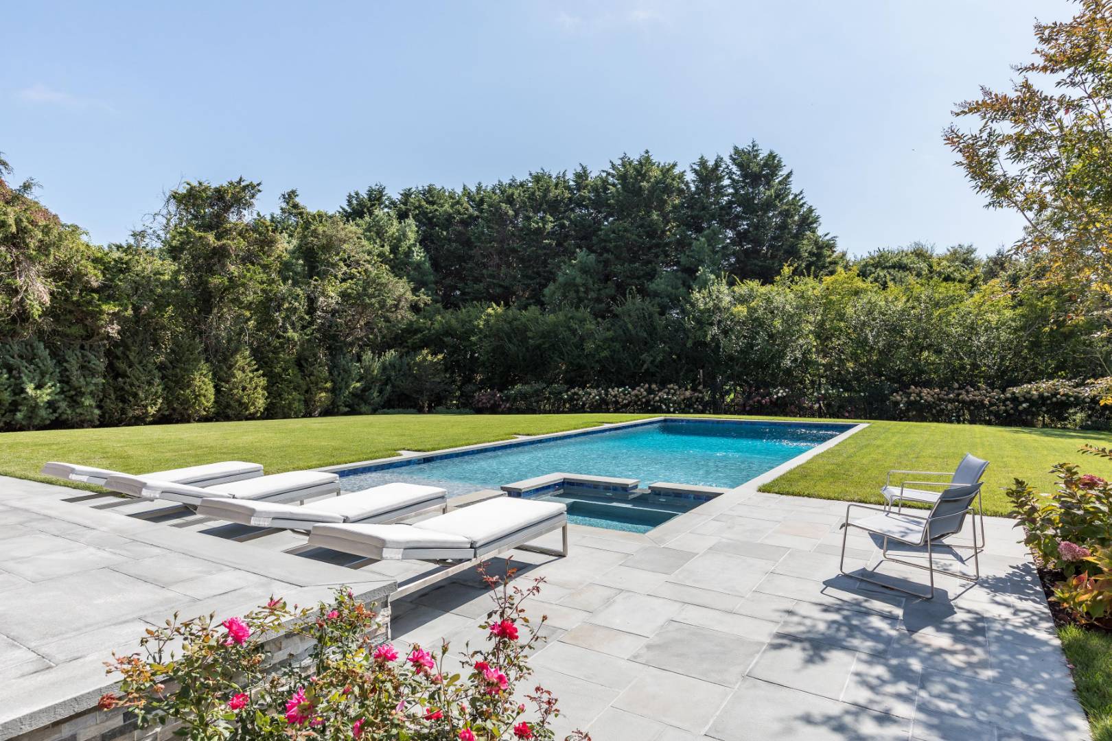 370 Pantigo Road East Hampton, NY 11937 - Photo 21 of 33 a view of swimming pool with lounge chair and trees in the background