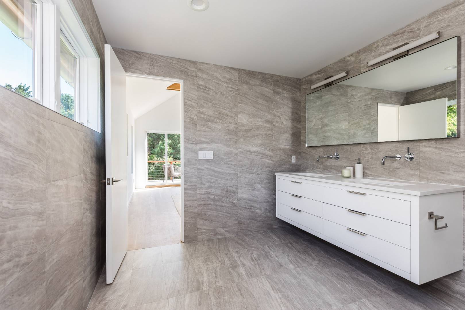 370 Pantigo Road East Hampton, NY 11937 - Photo 25 of 33 a bathroom with a double vanity sink a mirror and a shower