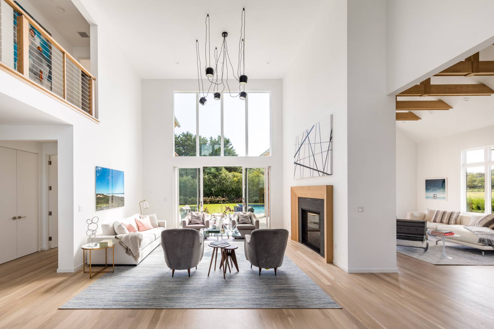 370 Pantigo Road East Hampton, NY 11937 - Photo 5 of 33 a living room with furniture a fireplace and a chandelier