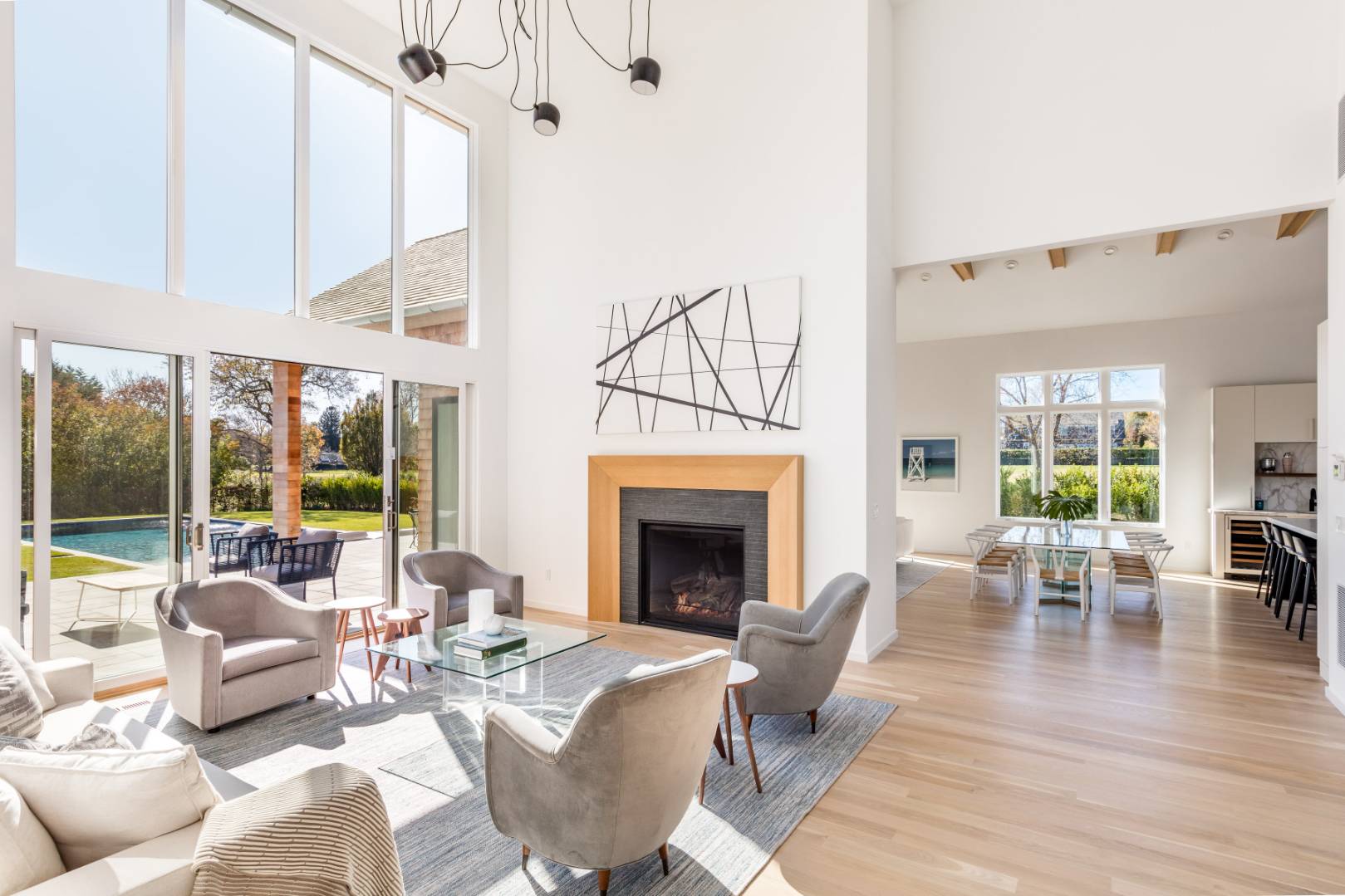 370 Pantigo Road East Hampton, NY 11937 - Photo 6 of 33 a living room with furniture a fireplace and a floor to ceiling window