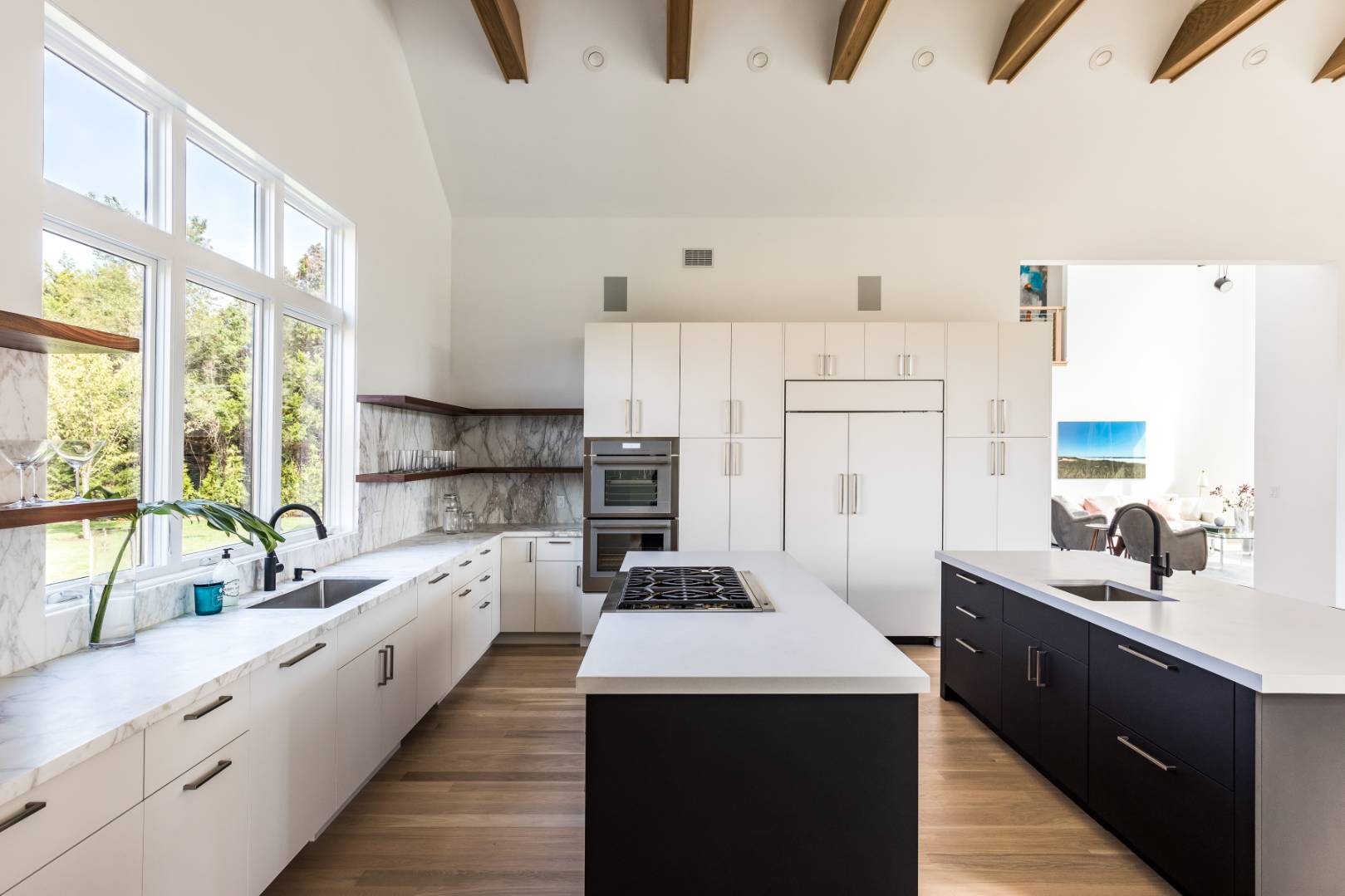 370 Pantigo Road East Hampton, NY 11937 - Photo 9 of 33 a kitchen with kitchen island a sink a stove a refrigerator cabinets and a large window