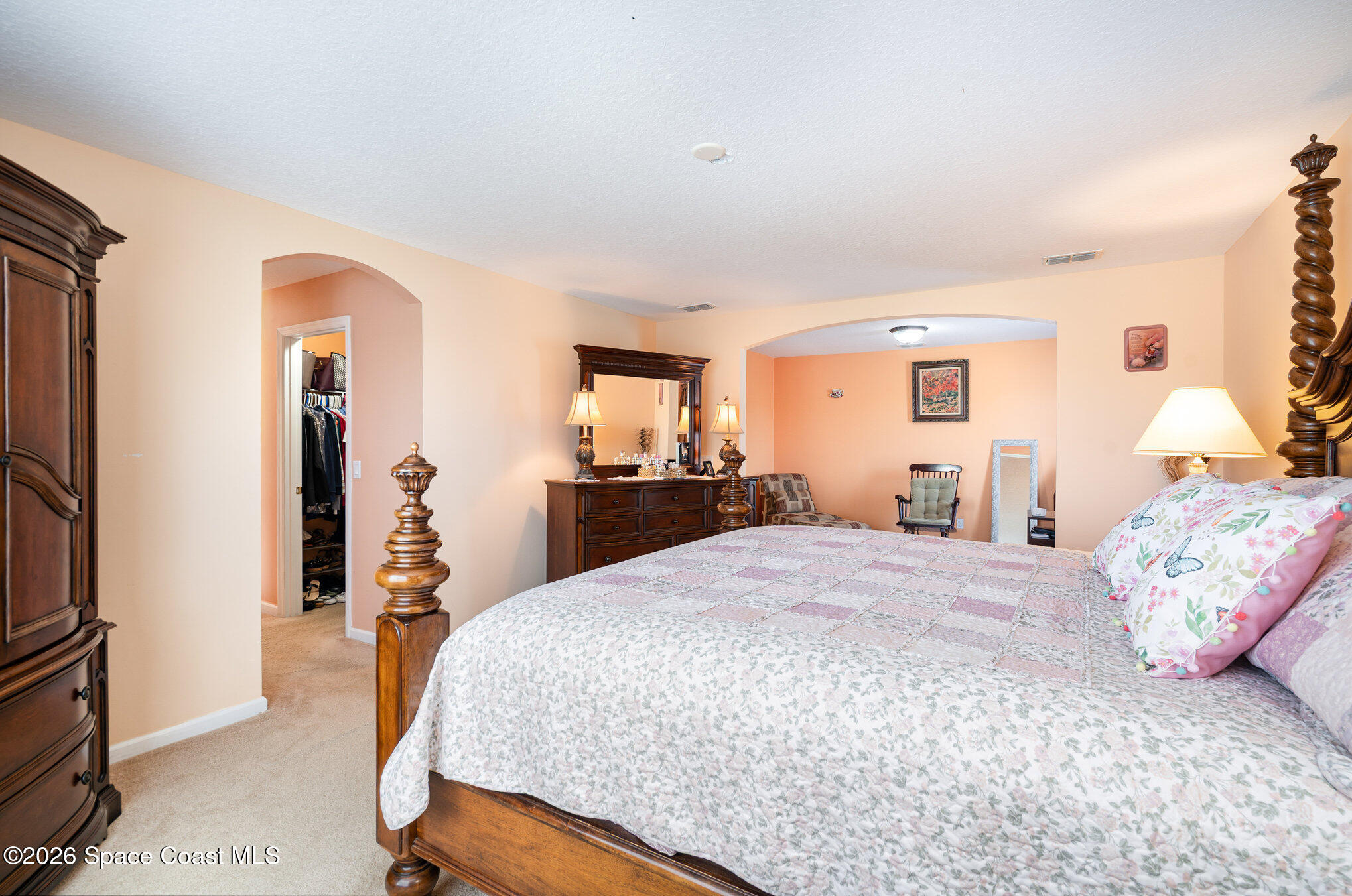 154 Wading Bird Circle Southwest Palm Bay, FL 32908 - Photo 14 of 45 a bedroom with a bed and a flat screen tv