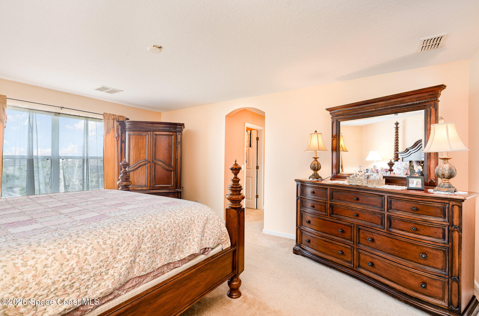 154 Wading Bird Circle Southwest Palm Bay, FL 32908 - Photo 16 of 45 a bedroom with a bed and large windows