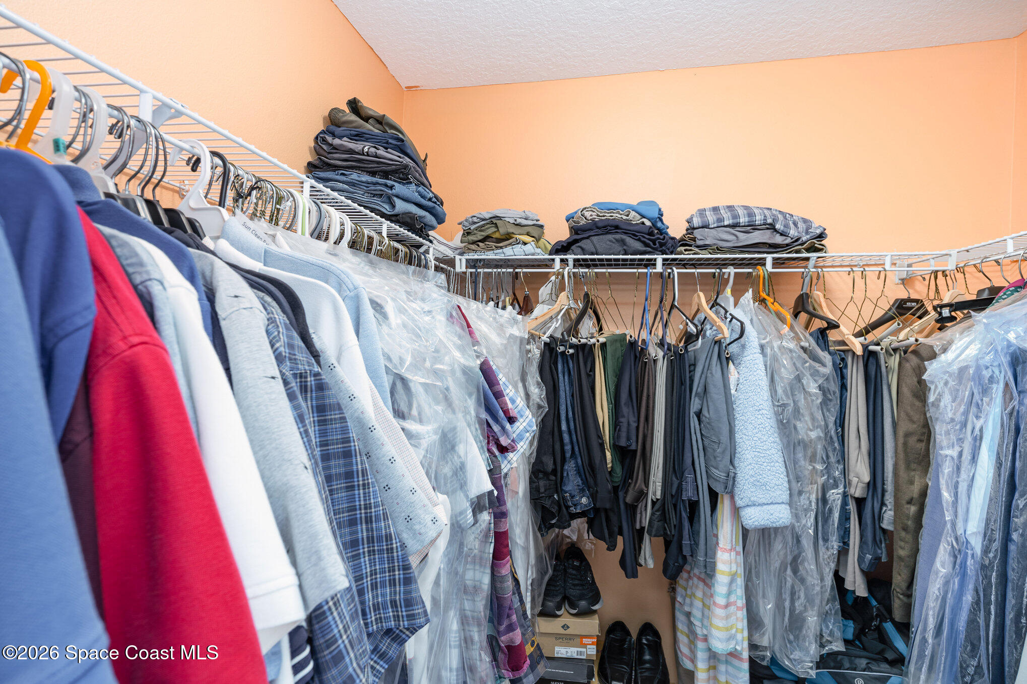 154 Wading Bird Circle Southwest Palm Bay, FL 32908 - Photo 19 of 45 a view of walk in closet with clothes and shoes