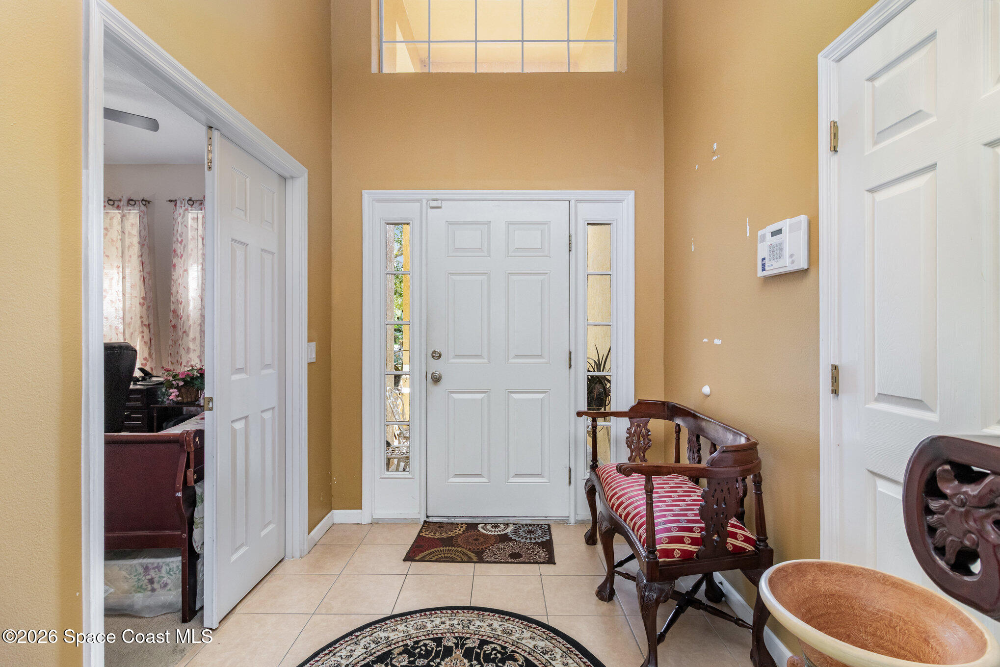154 Wading Bird Circle Southwest Palm Bay, FL 32908 - Photo 2 of 45 a living room with furniture and a gate