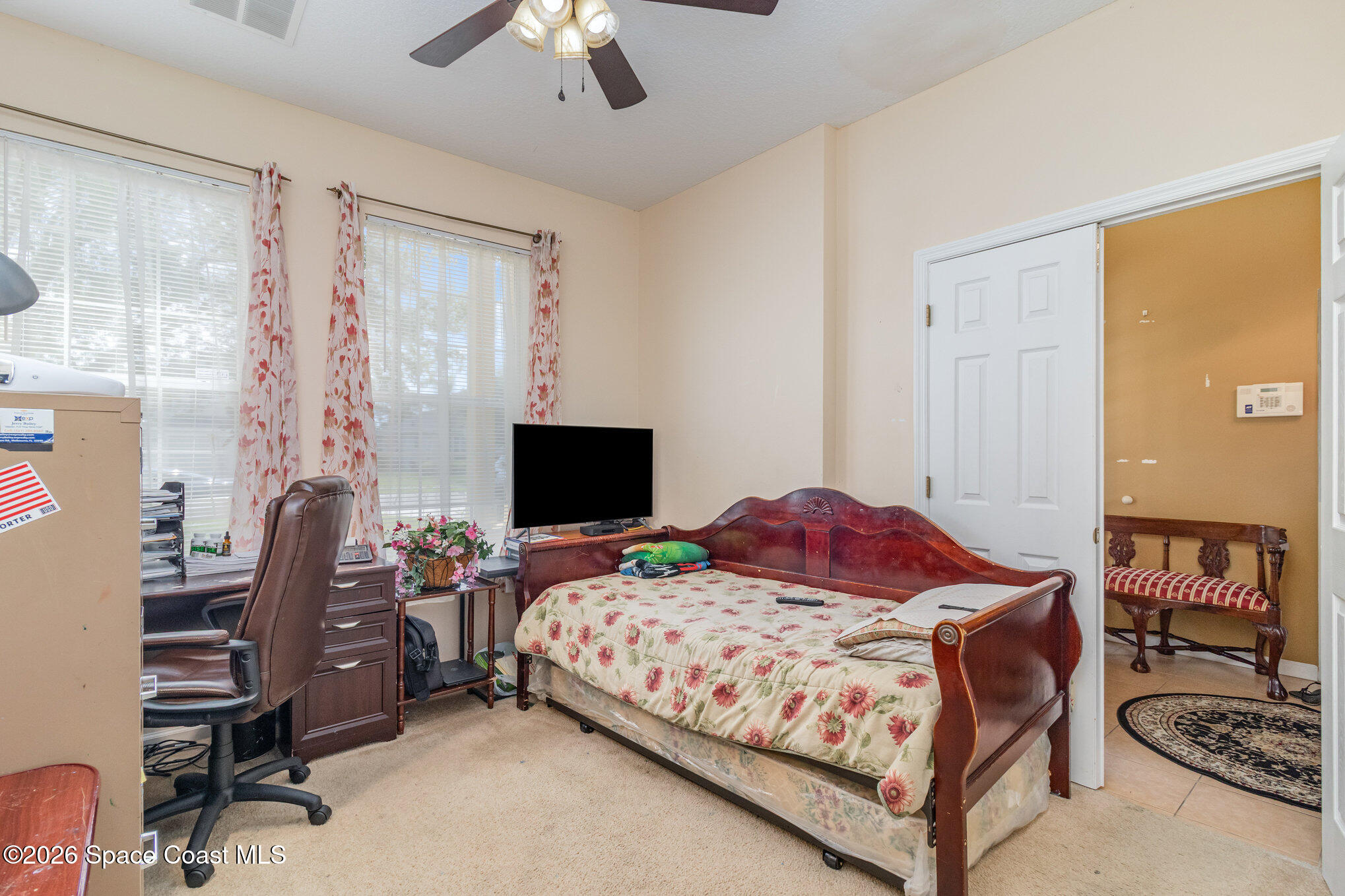 154 Wading Bird Circle Southwest Palm Bay, FL 32908 - Photo 21 of 45 a bedroom with a bed and a flat screen tv