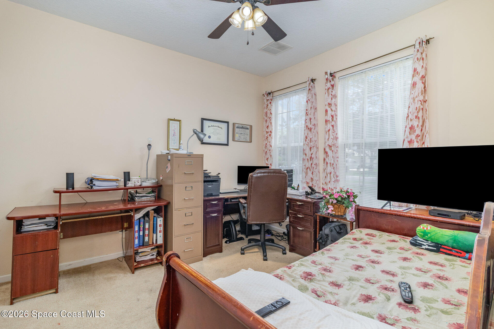 154 Wading Bird Circle Southwest Palm Bay, FL 32908 - Photo 22 of 45 a bedroom with a bed and a flat screen tv
