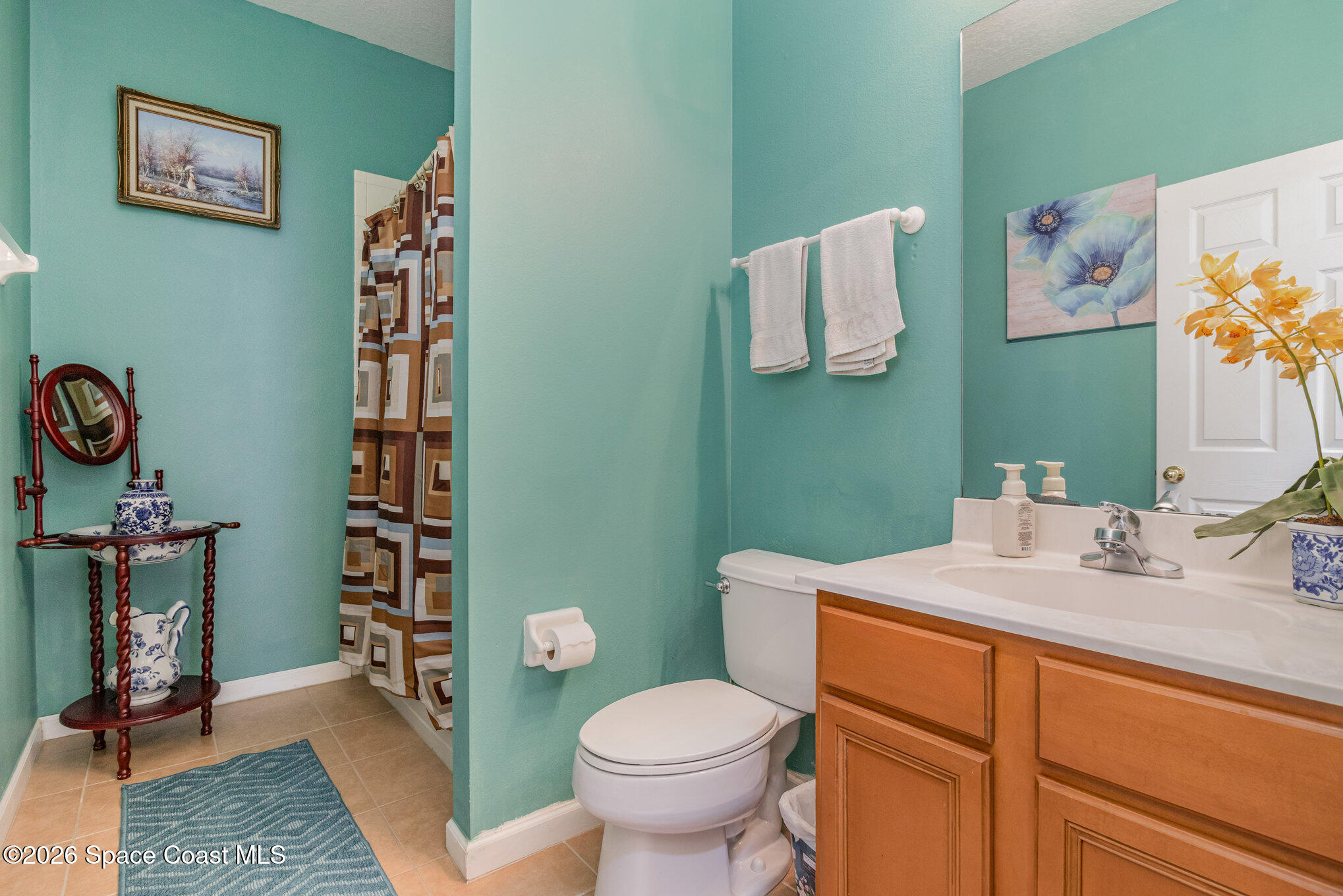154 Wading Bird Circle Southwest Palm Bay, FL 32908 - Photo 23 of 45 a bathroom with a toilet sink and mirror