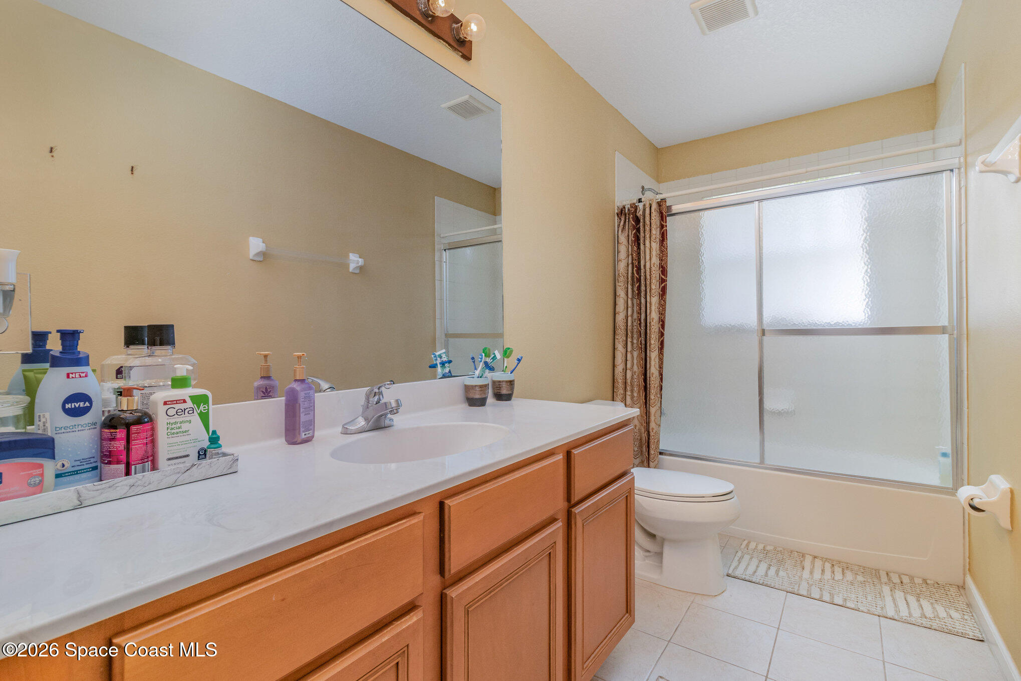 154 Wading Bird Circle Southwest Palm Bay, FL 32908 - Photo 26 of 45 a bathroom with a sink mirror vanity and toilet