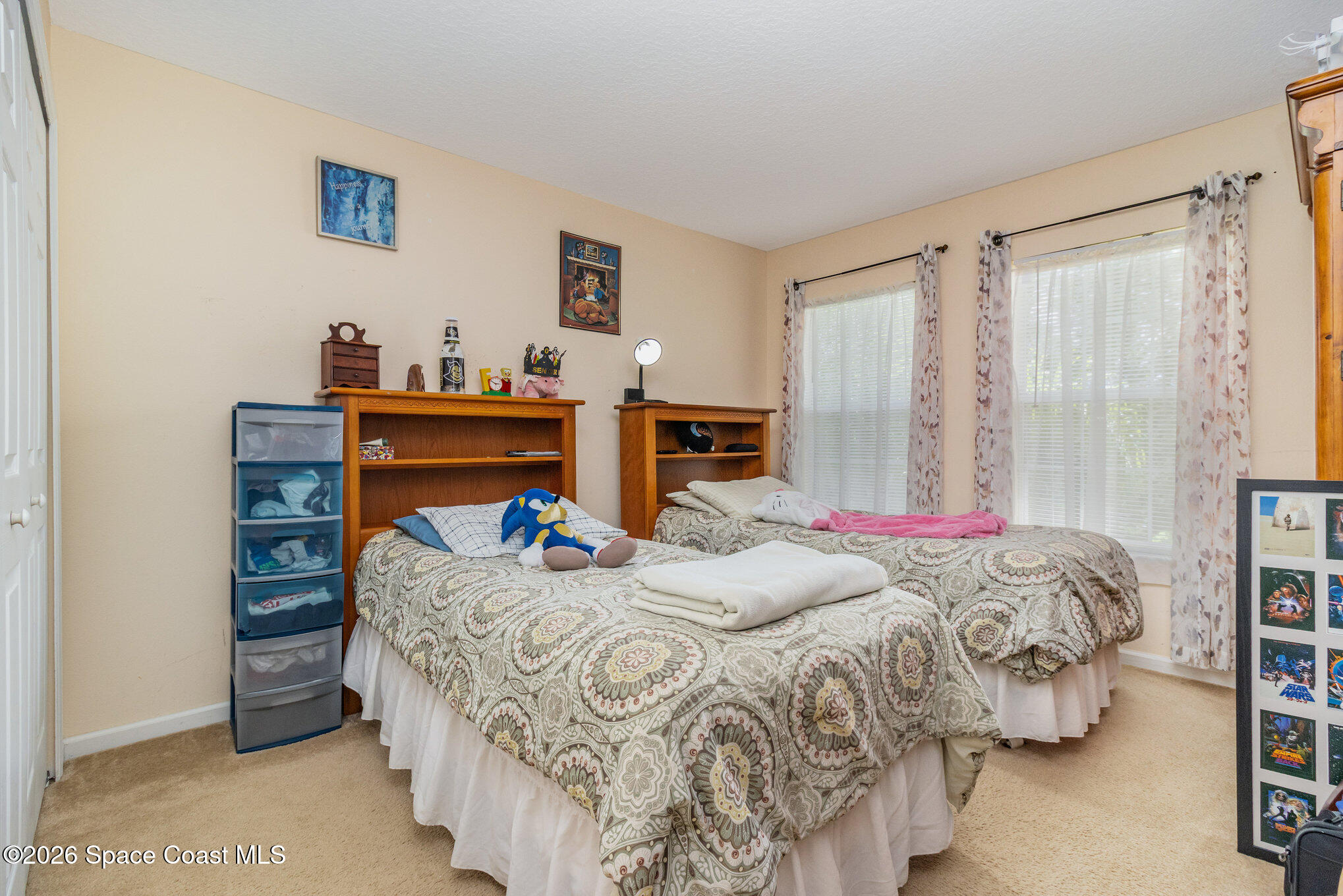 154 Wading Bird Circle Southwest Palm Bay, FL 32908 - Photo 27 of 45 a bedroom with a bed and a desk
