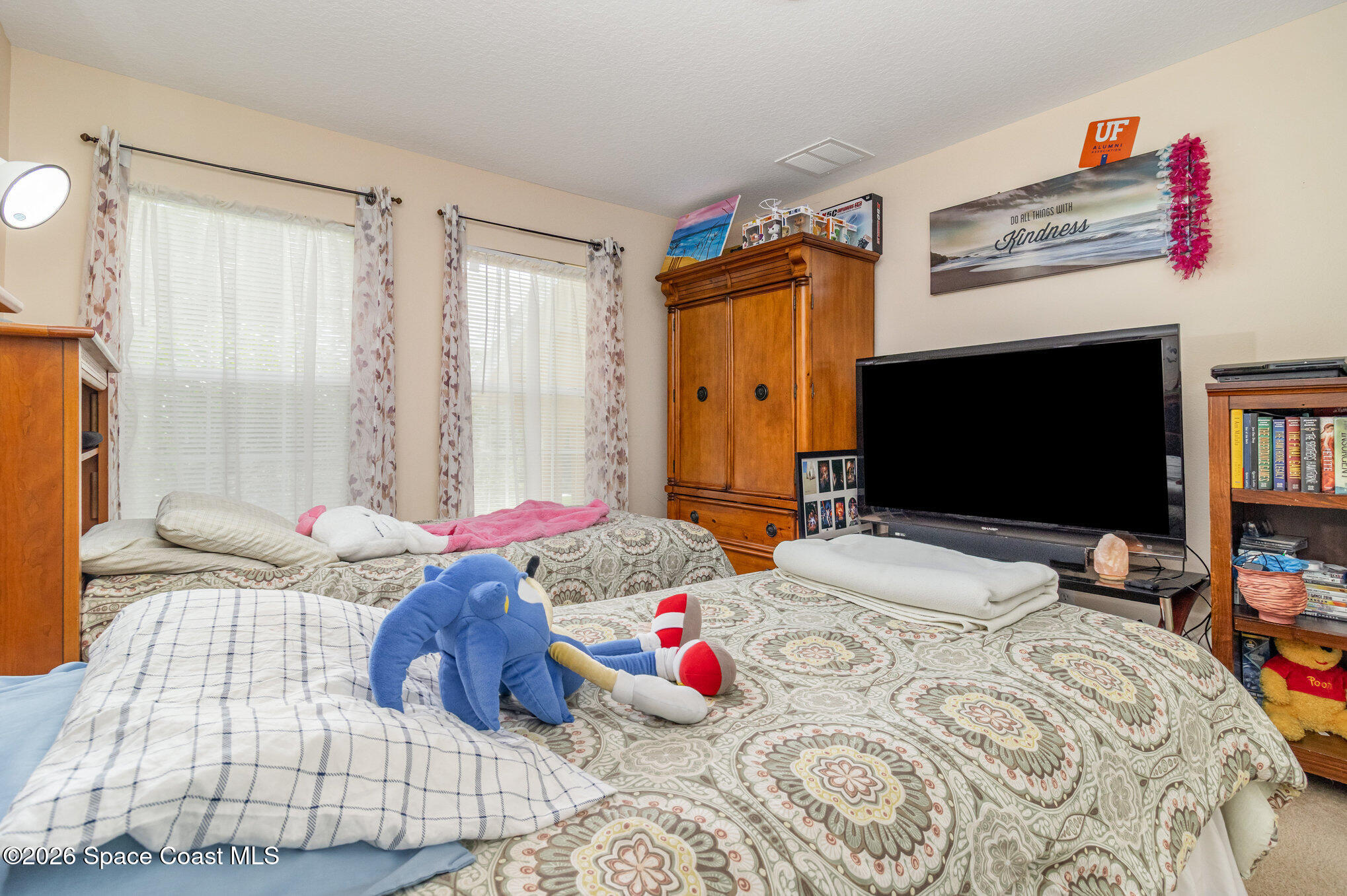 154 Wading Bird Circle Southwest Palm Bay, FL 32908 - Photo 28 of 45 a bedroom with a bed and wooden floor