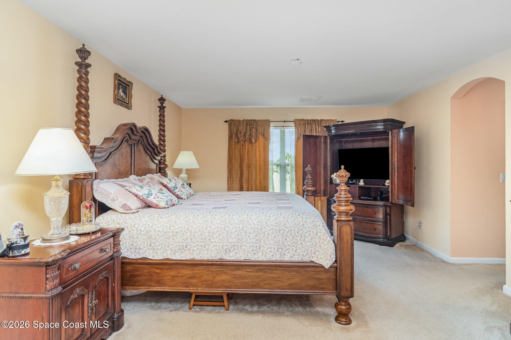 154 Wading Bird Circle Southwest Palm Bay, FL 32908 - Photo 29 of 45 a bed room with a bed and a lamp