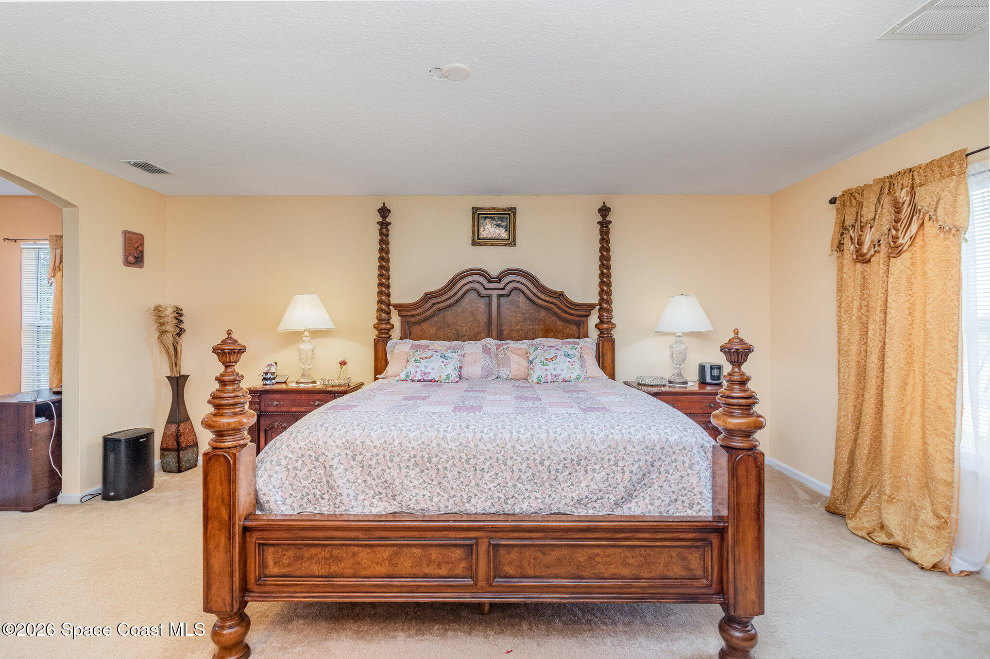 154 Wading Bird Circle Southwest Palm Bay, FL 32908 - Photo 31 of 45 a bedroom with a bed and wooden floor