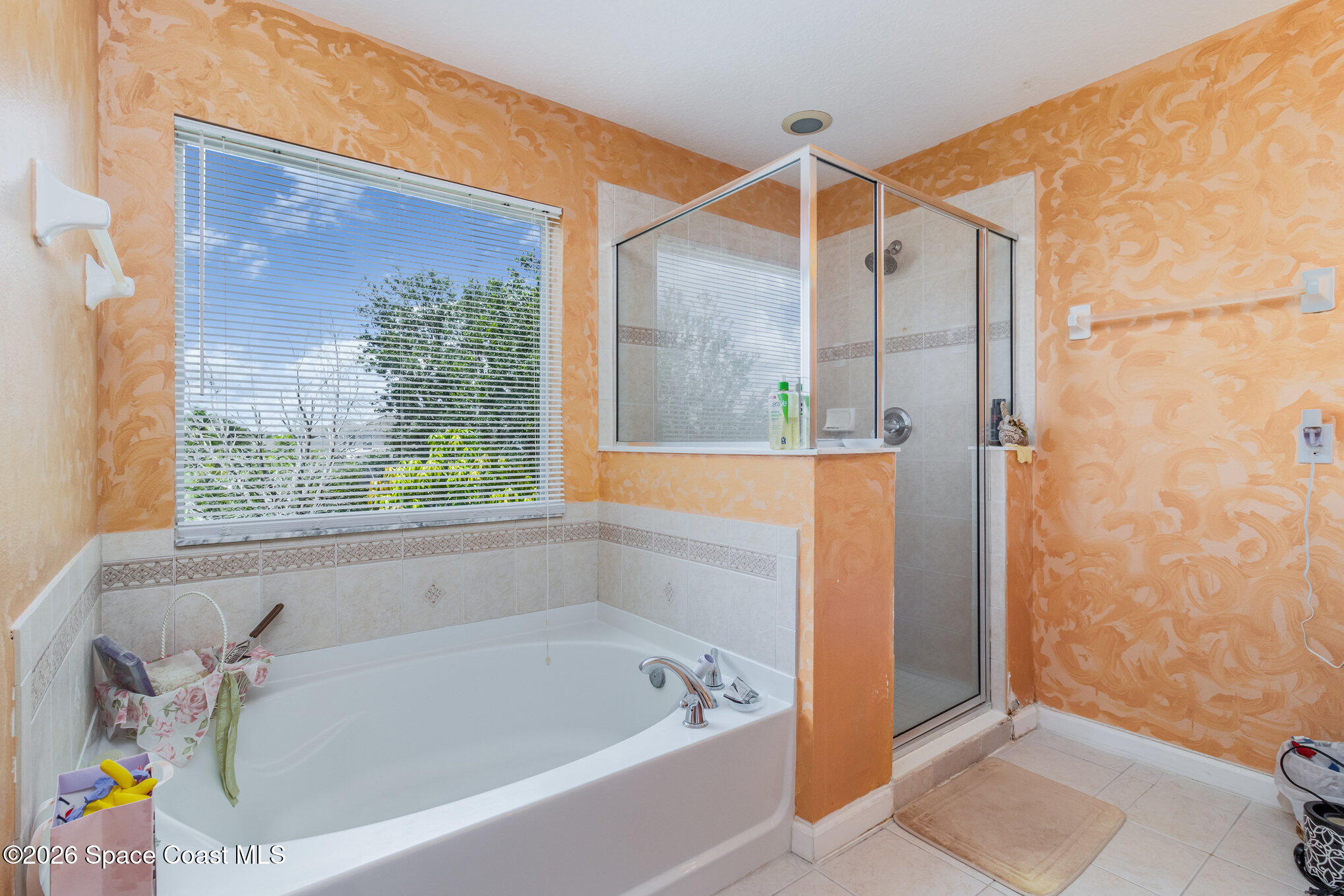 154 Wading Bird Circle Southwest Palm Bay, FL 32908 - Photo 33 of 45 a bathroom with a bathtub and a shower