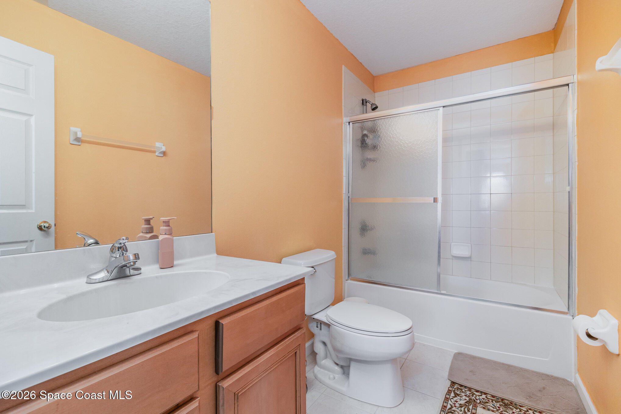 154 Wading Bird Circle Southwest Palm Bay, FL 32908 - Photo 36 of 45 a bathroom with a sink a toilet and shower