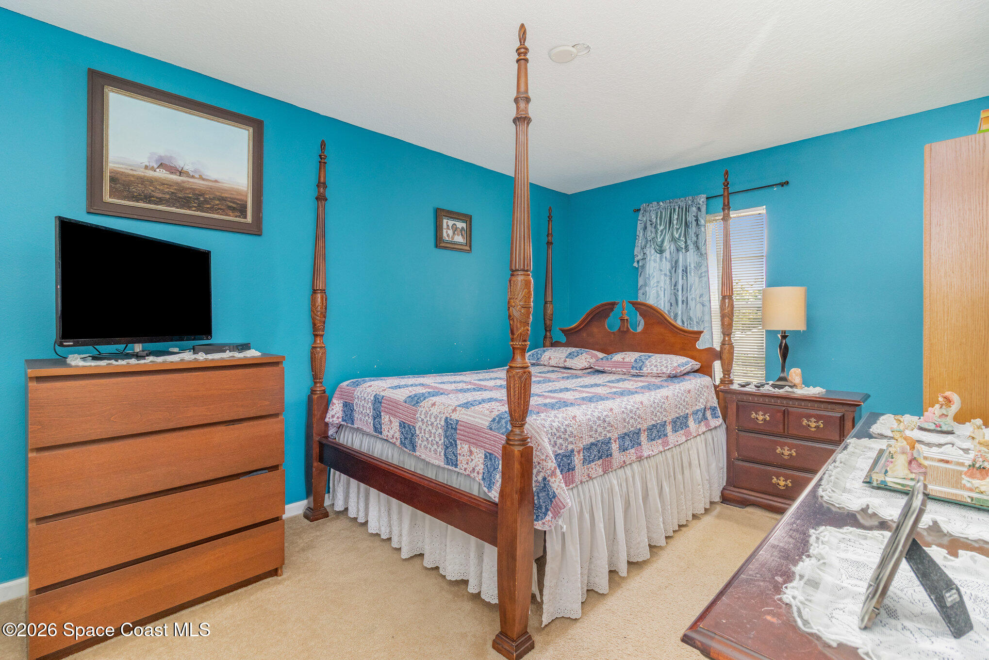 154 Wading Bird Circle Southwest Palm Bay, FL 32908 - Photo 37 of 45 a bedroom with a bed and a flat screen tv